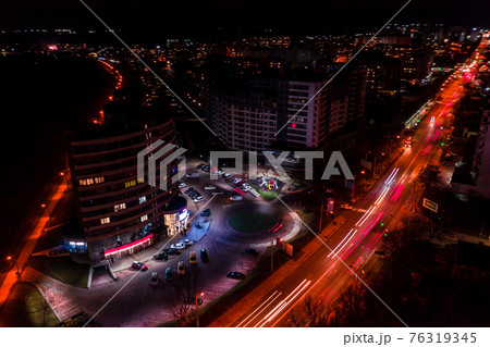 Night streets, highway and car traffic in the city of Ivano-Frankivsk, lights from car traffic, top view of the street. 76319345