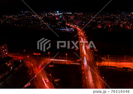 Night streets, highway and car traffic in the city of Ivano-Frankivsk, lights from car traffic, top view of the street. 76319346