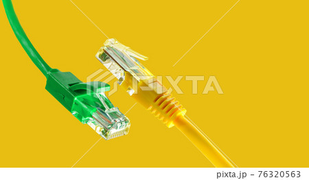 Ethernet cables with RJ45 plug on yellow background Ethernet cables with RJ45 plug on yellow background 76320563