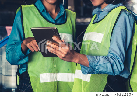 Female warehouse worker working at the storehouse 76322107