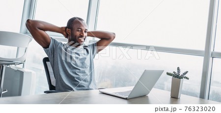 Website header of Young businessman looking on the screen in spacious bright office. 76323020