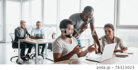 Website header of Three business colleagues discussing projects in modern office interior 76323023