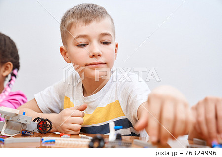Caucasian boy using building kit. 76324996