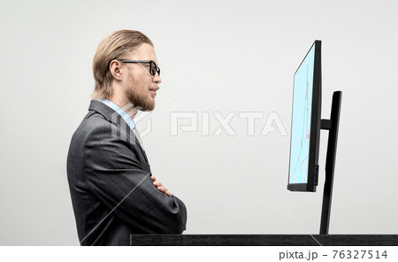 usinessman trader analyst in glasses spectacles looks into the screen 76327514