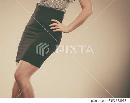 Woman wearing elegant tight dark black skirt Woman wearing elegant tight dark black skirt 76328893