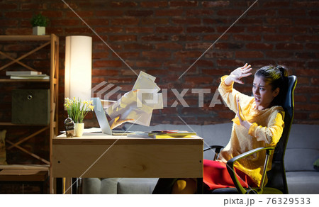 Young Caucasian woman talking with friend online through laptop. 76329533