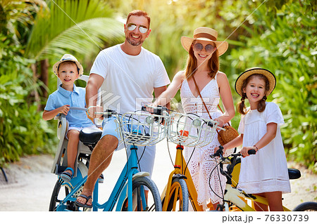 Joyful family with bicycles in nature Joyful family with bicycles in nature 76330739
