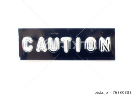 Embossed letter in word caution on black banner with white background Embossed letter in word caution on black banner with white background 76330883