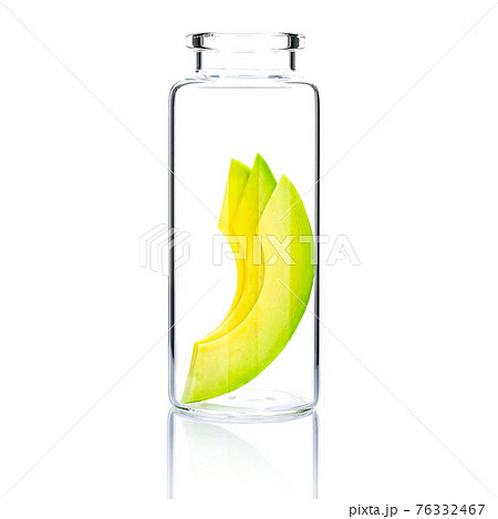 Homemade skin care with  avocado slice in a glass bottle isolated on white background. 76332467