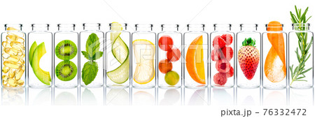 Homemade skin care with fruits ingredients avocado ,orange ,blueberry ,pomegranate ,kiwi ,lemon slice ,cucumber ,tamarind ,strawberry and raspberry in glass bottles isolated on white background. 76332472