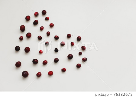 a heart made with fresh cranberries on white background 76332675