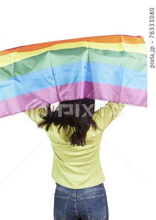 Attractive woman waving a gay LGBT rainbow flag. Her back is turned Attractive woman waving a gay LGBT rainbow flag. Her back is turned 76333080