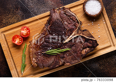 Grilled beef steak with spices on a wooden board 76333098