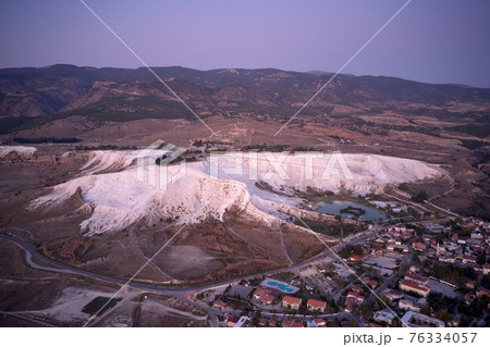 Aerial view of mountain lake with houses of resort town. 76334057