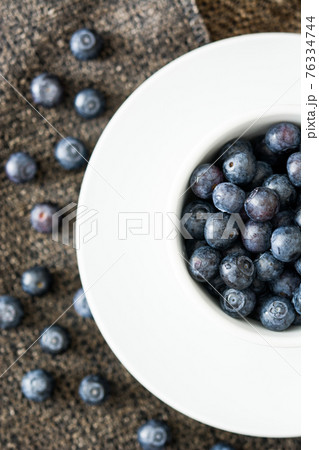 Fresh blueberries in a cup isolated on white background Fresh blueberries in a cup isolated on white background 76334744