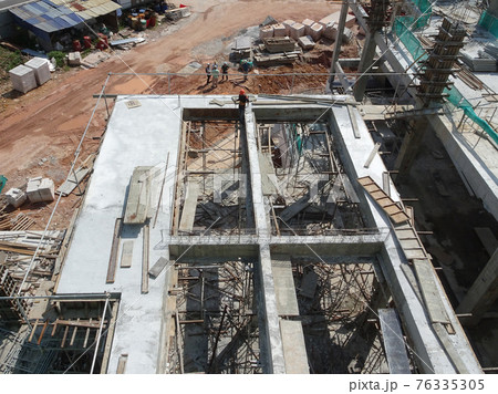MALACCA, MALAYSIA -MARCH 14, 2020: Construction workers working at height at the construction site. They are supplied with harnesses and other safety equipment to prevent them from having an accident. 76335305