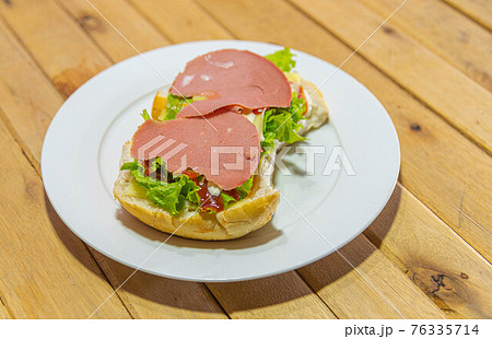bologna sandwich with lettuce, bread mayonnaise and ketchup 76335714