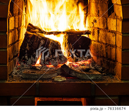 front view of burning firewood in heater 76336674