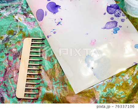 comb for marbling and wet paper on spotted surface 76337106