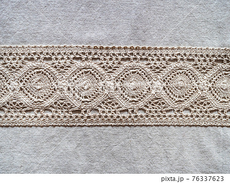 stripe of embroidery on gray linen cloth close up stripe of embroidery on gray linen cloth close up 76337623