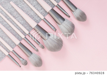 Set of makeup brushes on pink and gray background. Set of makeup brushes on pink and gray background. 76340928