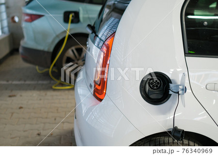 Electric cars charging at the charging station. Zero emission cars.  76340969