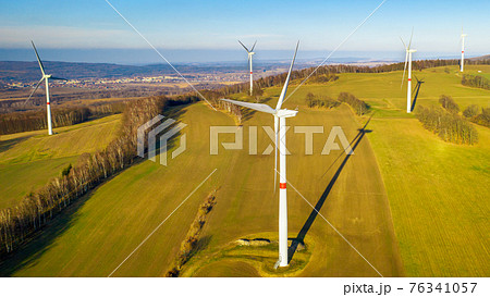 Aerial view of the windmills or turbines on the field. Renewal source for generation of electricity.  76341057