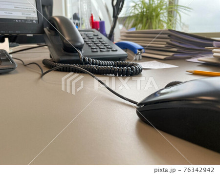 Black and white digital phone on the office table 76342942