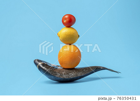 Raw fish and cooking ingredients isolated on a blue background. Raw fish and cooking ingredients isolated on a blue background. 76350431