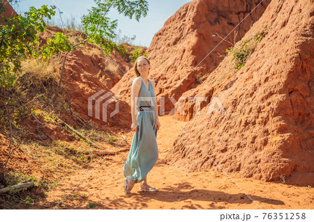 Woman tourist in red canyon, resumption of tourism concept 76351258