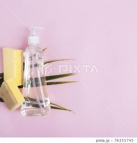 Soap dropper, dishwashing liquid, dish soap, washcloth. Pink, yellow background Soap dropper, dishwashing liquid, dish soap, washcloth. Pink, yellow background 76355745