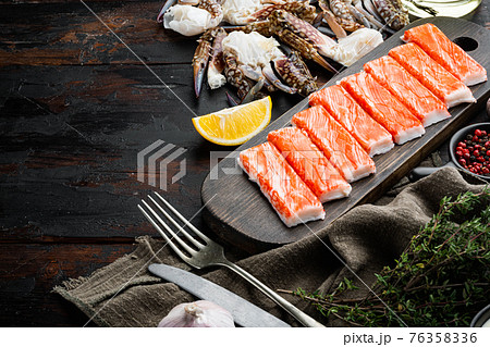Fresh Crab meat stick surimi , on dark wooden background , with copyspace and space for text Fresh Crab meat stick surimi , on dark wooden background , with copyspace and space for text 76358336