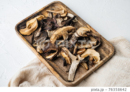 Dried porcini mushrooms, on white background Dried porcini mushrooms, on white background 76358642