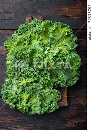 Kale salad leaves product of autumn, on old dark wooden table background, top view flat lay 76358707
