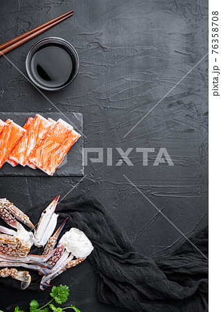 Fresh Crab meat stick surimi with blue swimming crab, on stone board, on black background, top view flat lay , with copyspace and space for text Fresh Crab meat stick surimi with blue swimming crab, on stone board, on black background, top view flat lay , with copyspace and space for text 76358708
