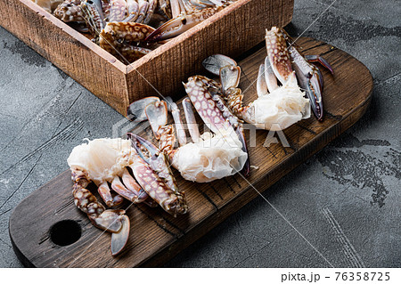 Fresh raw Blue Swimming Crab ocean gourme parts, on gray background Fresh raw Blue Swimming Crab ocean gourme parts, on gray background 76358725