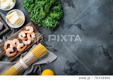 Spaghetti with parmesan flavored with dill, shrimp cooking ingredients, on gray background , with copyspace and space for text Spaghetti with parmesan flavored with dill, shrimp cooking ingredients, on gray background , with copyspace and space for text 76358966