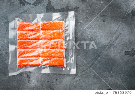Crab stick surimi vacuum pack, on gray background, top view flat lay , with copyspace and space for text Crab stick surimi vacuum pack, on gray background, top view flat lay , with copyspace and space for text 76358970