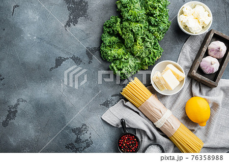 Ingredients for making pasta. Raw spaghetti, on gray background, top view flat lay , with copyspace and space for text Ingredients for making pasta. Raw spaghetti, on gray background, top view flat lay , with copyspace and space for text 76358988