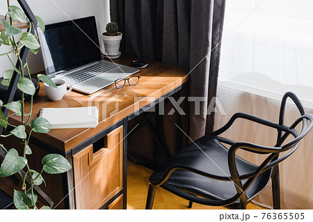 Modern workplace at home with laptop on wooden table Modern workplace at home with laptop on wooden table 76365505