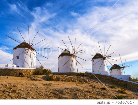 Famous tourist attraction of Mykonos, Cyclades, Greece. Four traditional whitewashed windmills by waterfront. Summer, travel destination, iconic view. Famous tourist attraction of Mykonos, Cyclades, Greece. Four traditional whitewashed windmills by waterfront. Summer, travel destination, iconic view. 76367617