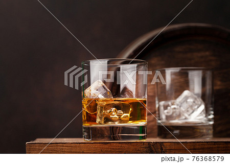 Scotch whiskey glass and old barrel Scotch whiskey glass and old barrel 76368579