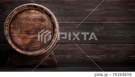 Mug of light lager beer and old wooden barrel 76368656