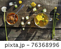 Medicinal Tea from dandelion in  glass cup, honey dandelion  on wooden rustic  table 76368996