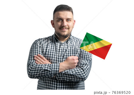 White guy holding a flag of Republic of the Congo smiling confident with crossed arms isolated on a white background White guy holding a flag of Republic of the Congo smiling confident with crossed arms isolated on a white background 76369520
