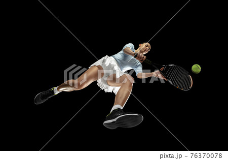 Female professional tennis player in action, motion isolated on black background, look from the bottom. Concept of sport, movement, energy and dynamic. 76370078
