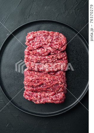 Mince. Ground meat with ingredients for cooking, on black background, top view flat lay Mince. Ground meat with ingredients for cooking, on black background, top view flat lay 76370279