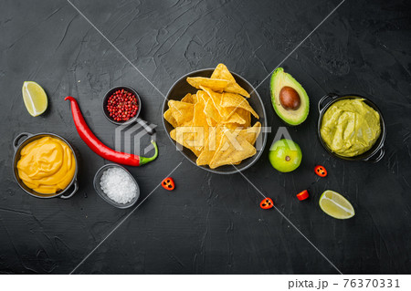 Different dips and sauces for nachos, on black background, top view or flat lay 76370331