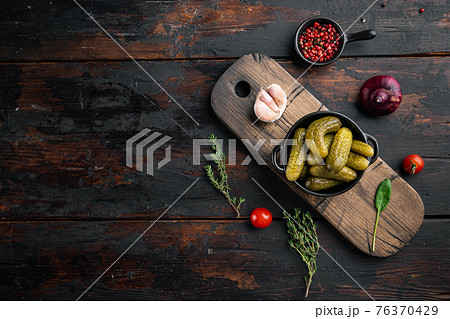 Homemade canning. Marinated cucumbers gherkins, on old dark wooden table background, top view flat lay , with space for text copyspace 76370429