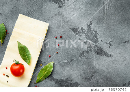 Lasagna dough sheets, with seasoning and herb, on gray stone background, top view, flat lay, with copy space for text 76370742